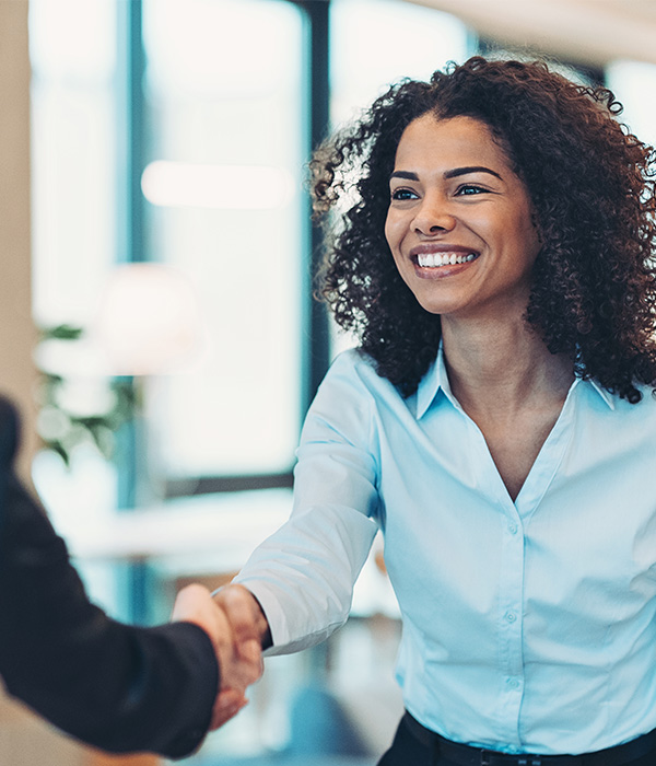 Smiling businesswoman greeting a colleague on a meeting